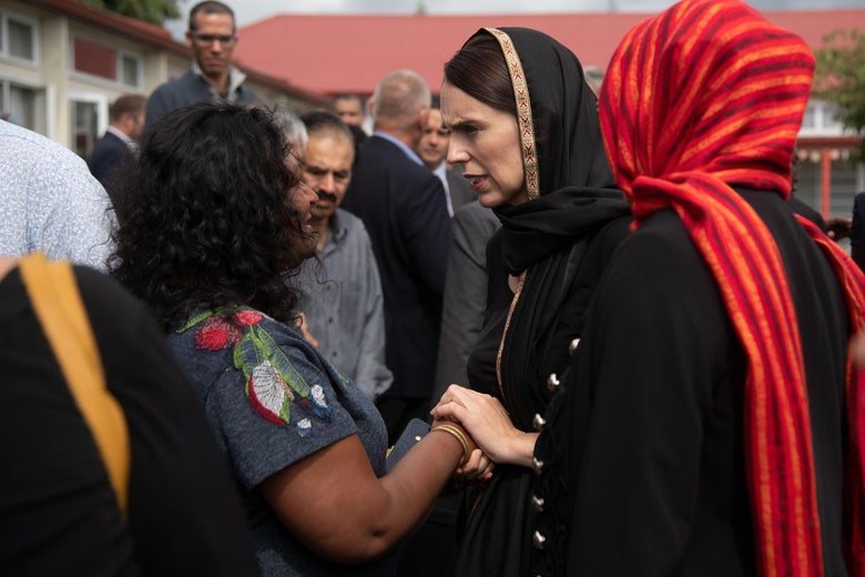 New Zealand Prime Minister Jacinda Ardern (C) speaks with a representative of the refugee centre during a visit to the Canterbury Refugee Centre in Christchurch on March 16, 2019.